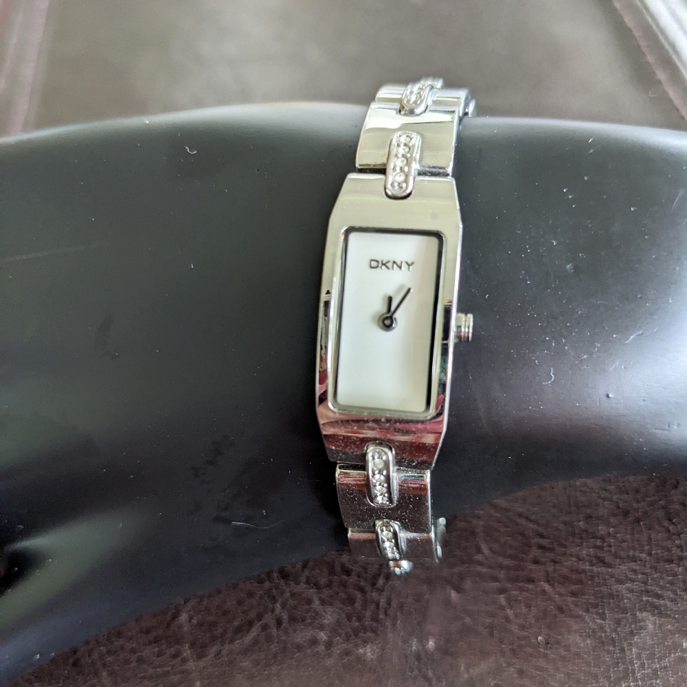 DKNY stainless steel ladies watch with white face and CZs